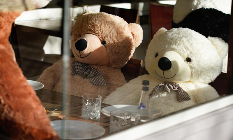 Stuffed toy bears are seen seated at a table in a pizza restaurant in Warsaw, Poland, Feb. 27, 2021.Photo:Xinhua