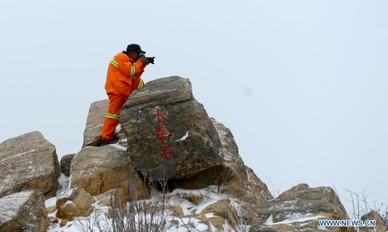 Rong Ximin takes photos at Tuoliang National Nature Reserve, north China's Hebei Province, Feb. 28, 2021. Rong Ximin, a ranger of Yunding Grassland in Tuoliang National Nature Reserve, came to work in the reserve with his wife Shi Shufang in 2009.Photo:Xinhua