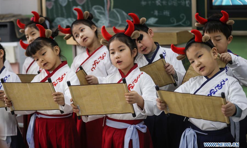 Primary students wearing traditional costumes and ox-themed headpieces perform in class on their first day of the new semester at a primary school in Shenyang, northeast China's Liaoning Province, March 1, 2021. Students returned to school for the spring semester on Monday in many parts of China amid coordinated epidemic control efforts. (Photo: Xinhua)