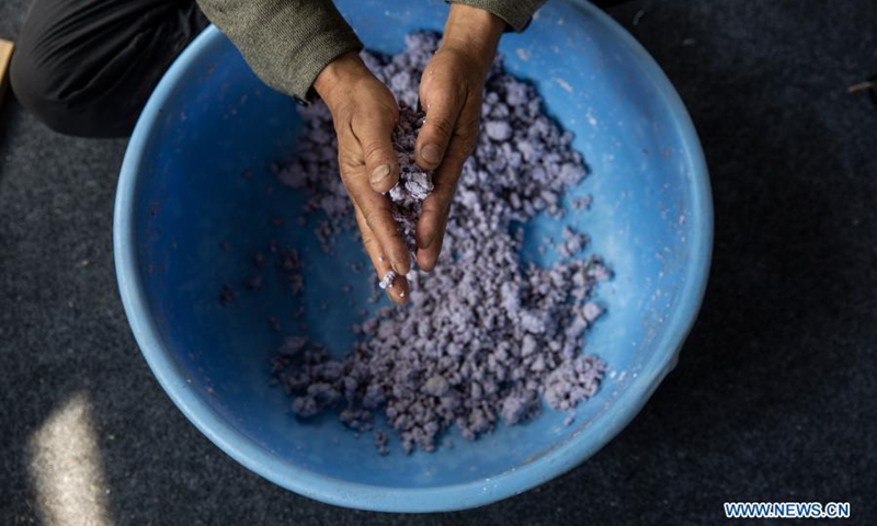 A worker makes paper pulp to create a papier mache craft at a workshop in the downtown area of Srinagar city, the summer capital of Indian-controlled Kashmir, March 1, 2021. Papier mache is an art of moulding paper and flour and later sculpting it to create different crafts.(Photo: Xinhua)