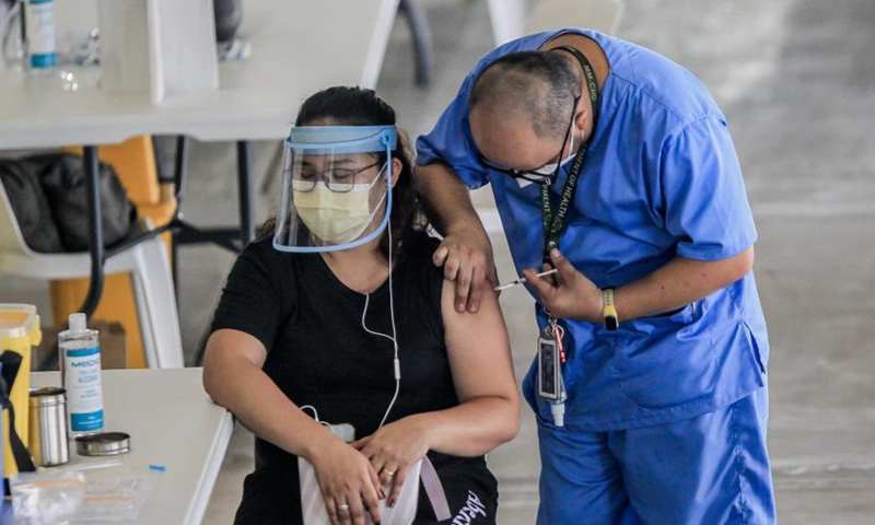 A healthcare worker receives a dose of China's Sinovac COVID-19 vaccine at the Marikina Sports Center in Marikina City, the Philippines, March 2, 2021. The Philippines has begun their COVID-19 vaccination campaign after the country received the shipment of the Sinovac vaccine CoronaVac from China.Photo:Xinhua
