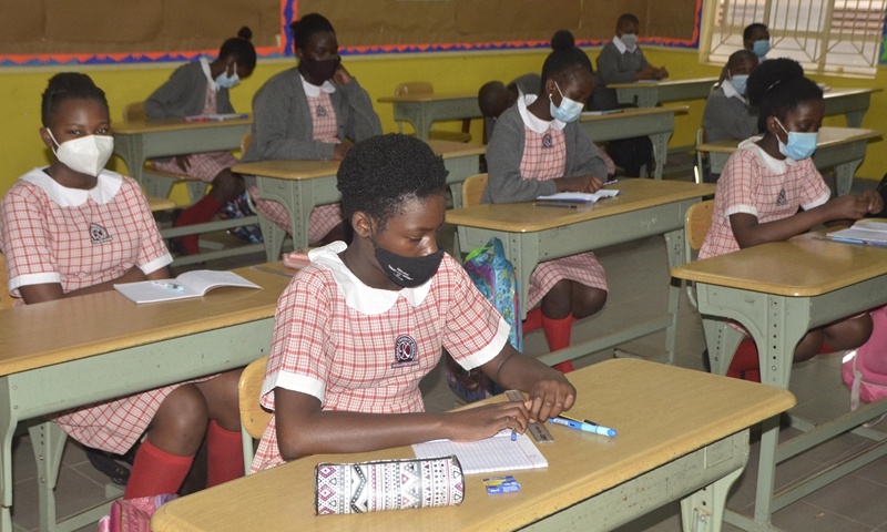 Students wearing face masks attend a class at a school in Kampala, Uganda, March 1, 2021. (Photo: Xinhua)