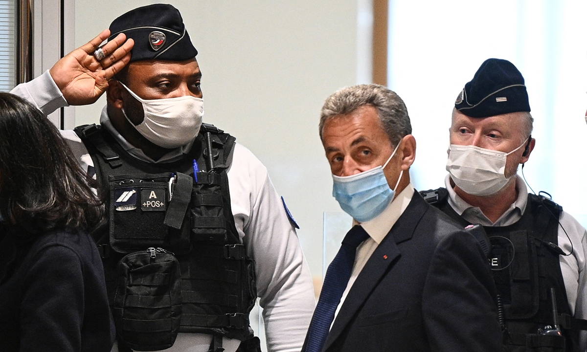 Former French president Nicolas Sarkozy (middle) arrives at the Paris court house to hear the final verdict on Monday. Photo: AFP