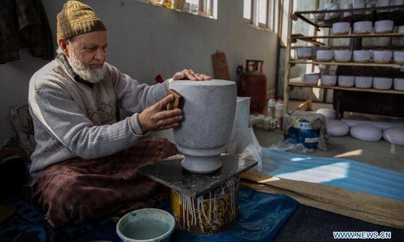 A worker works on a papier mache craft at a workshop in the downtown area of Srinagar city, the summer capital of Indian-controlled Kashmir, March 1, 2021. Papier mache is an art of moulding paper and flour and later sculpting it to create different crafts.(Photo: Xinhua)
