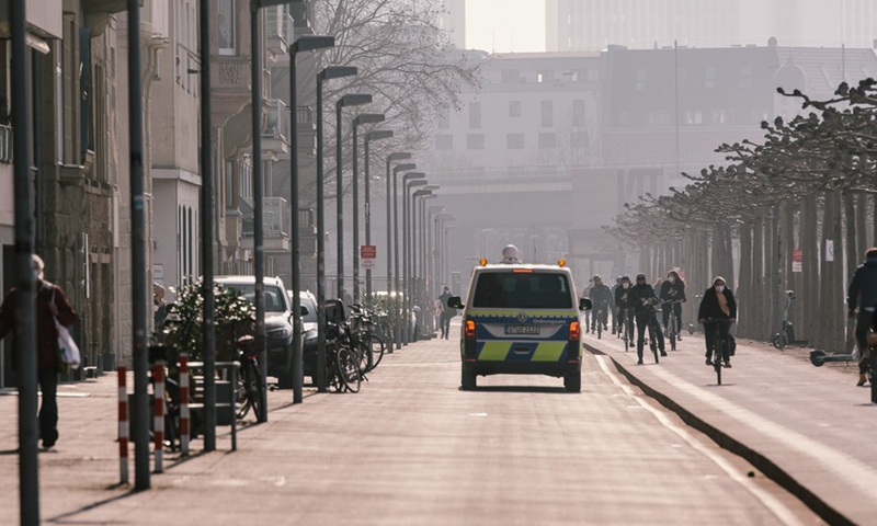 A police vehicle broadcasting anti-epidemic measures runs near Rhine river amid the COVID-19 pandemic in Dusseldorf, Germany, Feb. 27, 2021.(Photo: Xinhua)