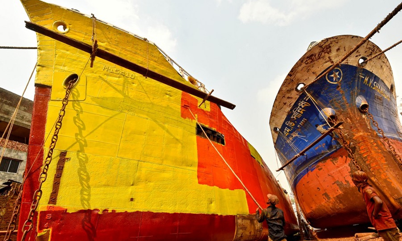 A worker paints a ship at a dockyard in Keraniganj on the outskirts of Dhaka, Bangladesh, March 1, 2021.(Photo: Xinhua)