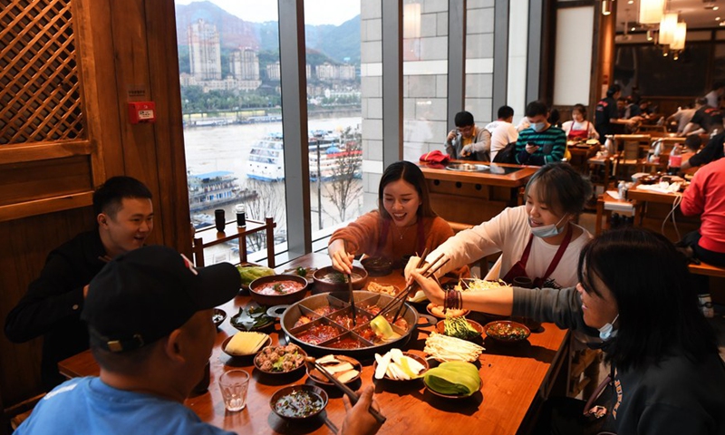 Customers enjoy the meals at a hot pot restaurant in Southwest China's Chongqing municipality, on Oct 5, 2020. [Photo/Xinhua]