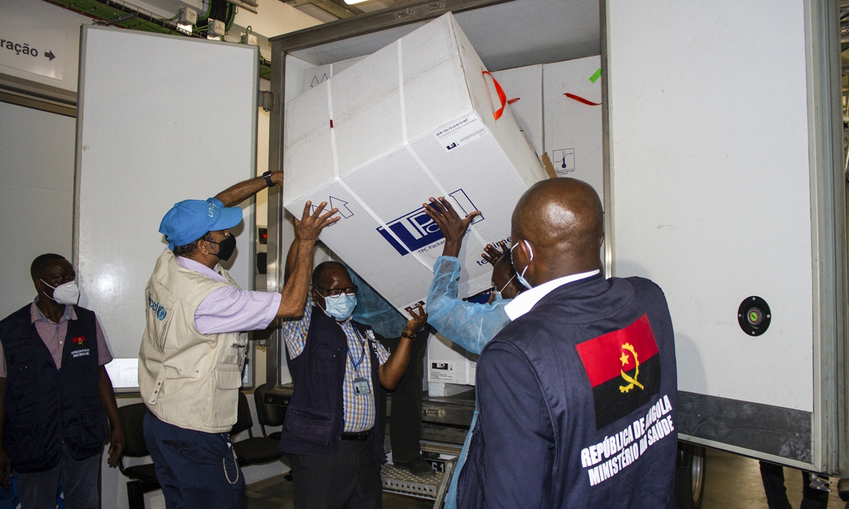 Health professionals unload the first batch of AstraZeneca/Oxford vaccines at the Central Vaccine depot, where they will be stored in Luanda, Angola on Tuesday. Photo: AFP