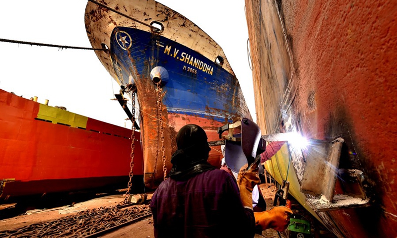 Mechanics weld a ship at a dockyard in Keraniganj on the outskirts of Dhaka, Bangladesh, March 1, 2021.(Photo: Xinhua)