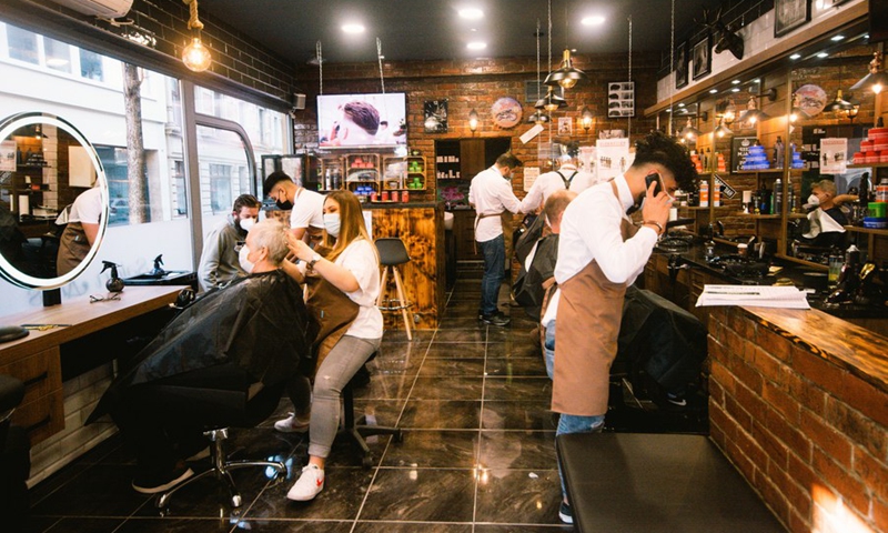 Employees serve customers at a hair salon amid the COVID-19 pandemic in Cologne, Germany, March 1, 2021. Hair salons in Germany reopened on Monday with COVID-19 prevention measures.(Photo: Xinhua)