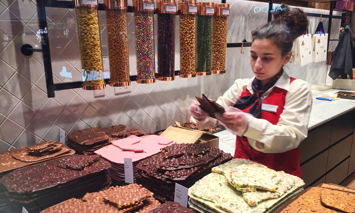 Worker selects some of the sweet and elegant chocolates at the Laederach Swiss chocolatier shop in Toronto, Ontario, Canada. Photo: AFP