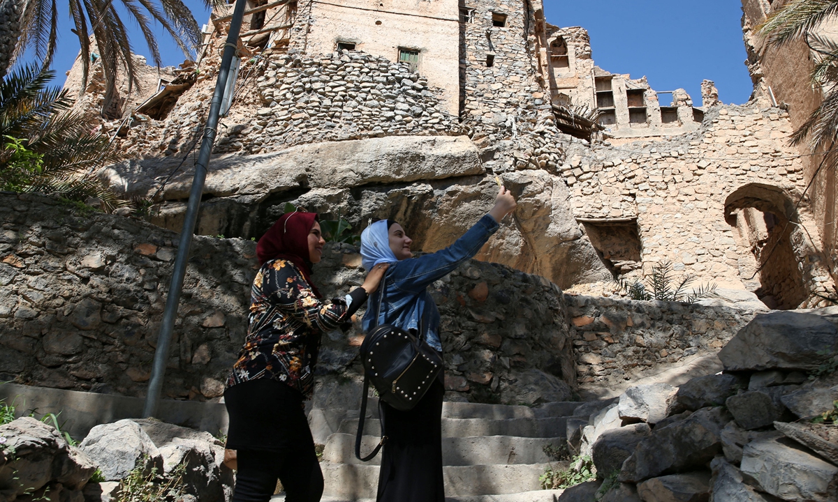 Egyptian tourists take a selfie as they tour the village of Misfat al-Abriyeen on February 8. Photo: AFP
