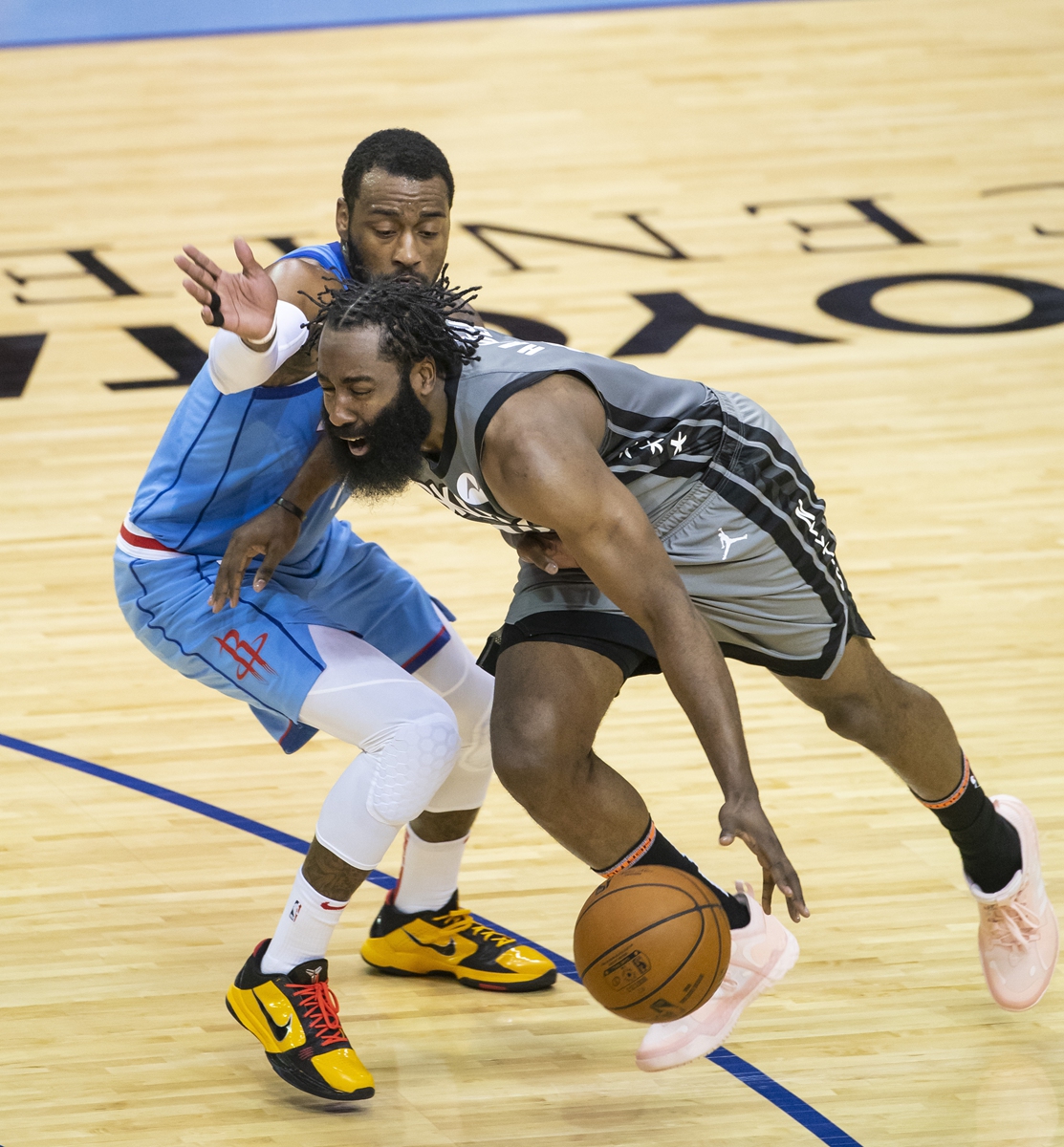 Brooklyn Nets guard James Harden drives around Houston Rockets guard John Wall on Wednesday in Houston. Photo: VCG