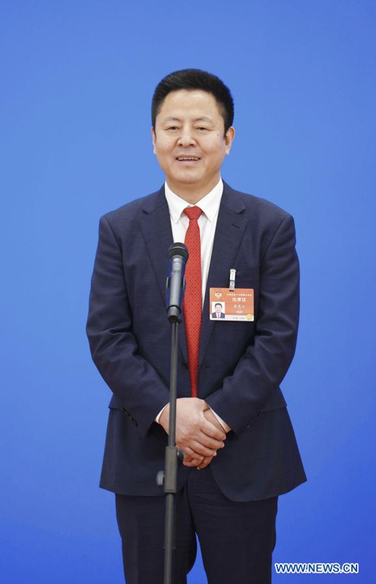 Ao Hushan, a member of the 13th National Committee of the Chinese People's Political Consultative Conference (CPPCC), is interviewed via video link ahead of the opening of the fourth session of the 13th CPPCC National Committee at the Great Hall of the People in Beijing, capital of China, March 4, 2021. (Xinhua/Xing Guangli)