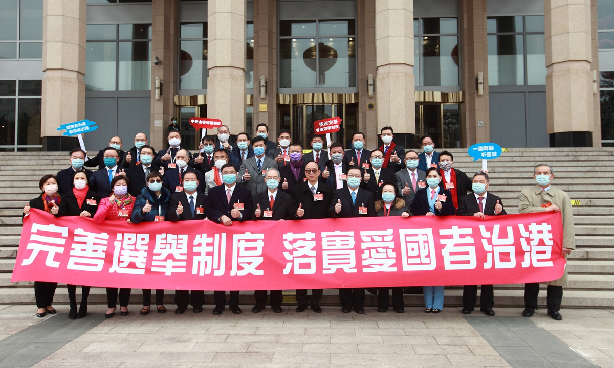 All Hong Kong deputies to the National People's Congress post for a group photo to show support to the draft decision to improve Hong Kong's electoral system in Beijing on Friday. 