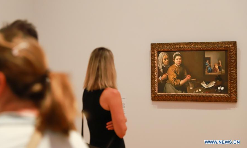 A visitor views a painting at the media preview of an exhibition in Canberra, Australia, on March 3, 2021. An exhibition with 61 paintings from the National Gallery London spanning nearly 500 years will start on Friday. It brought together works of 56 of European history's greatest artists including Botticelli, Titian, Velazquez, Rembrandt, Vermeer, Goya, Van Dyck, Canaletto, Turner, Renoir, Cezanne, Monet and Gauguin, and will run until June 14.Photo:Xinhua