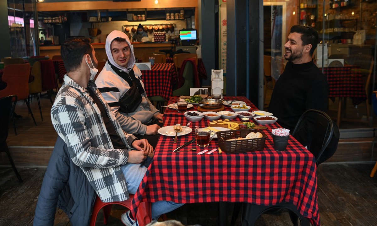Customers eat at a restaurant in Besiktas in Istanbui on Tuesday. Photo: AFP