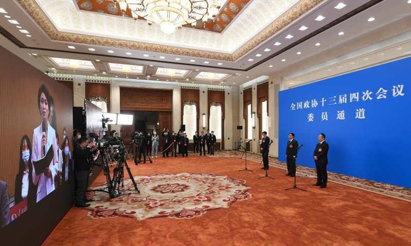 Members of the 13th National Committee of the Chinese People's Political Consultative Conference (CPPCC) are interviewed via video link ahead of the opening of the fourth session of the 13th CPPCC National Committee at the Great Hall of the People in Beijing, capital of China, March 4, 2021. (Xinhua/Zhang Haofu) 