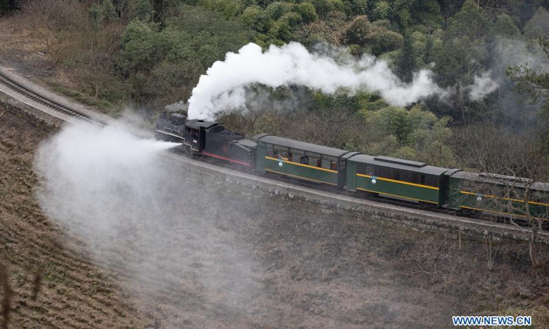 A train runs on a narrow gauge railway in Qianwei County, southwest China's Sichuan Province, March 2, 2021. The old-fashioned steam train, running on a narrow gauge railway in Qianwei County, serves mainly in sightseeing. As increasing number of tourists visit the county in recent years, the train itself has become an attraction providing a journey of reminiscence. (Photo: Xinhua)