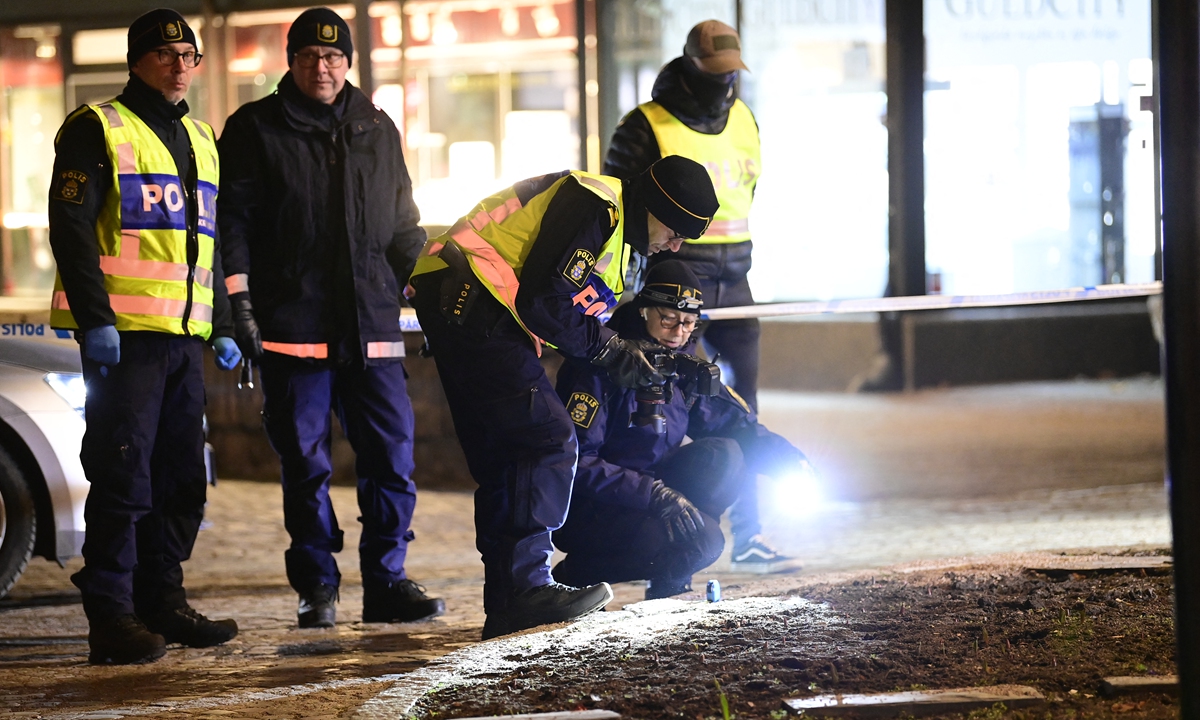 Police work at the scene where a man attacked eight people with a 