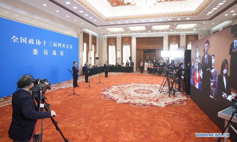 Members of the 13th National Committee of the Chinese People's Political Consultative Conference (CPPCC) are interviewed via video link ahead of the opening of the fourth session of the 13th CPPCC National Committee at the Great Hall of the People in Beijing, capital of China, March 4, 2021. (Xinhua/Xing Guangli)