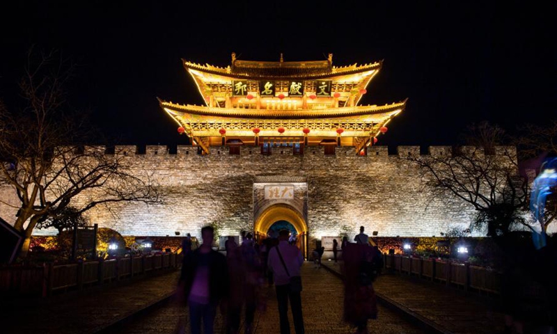 Tourists are seen at the south gate of the old town of Dali, southwest China's Yunnan Province, March 3, 2021. The charming night view of the old town of Dali attracts a lot of tourists.Photo:Xinhua