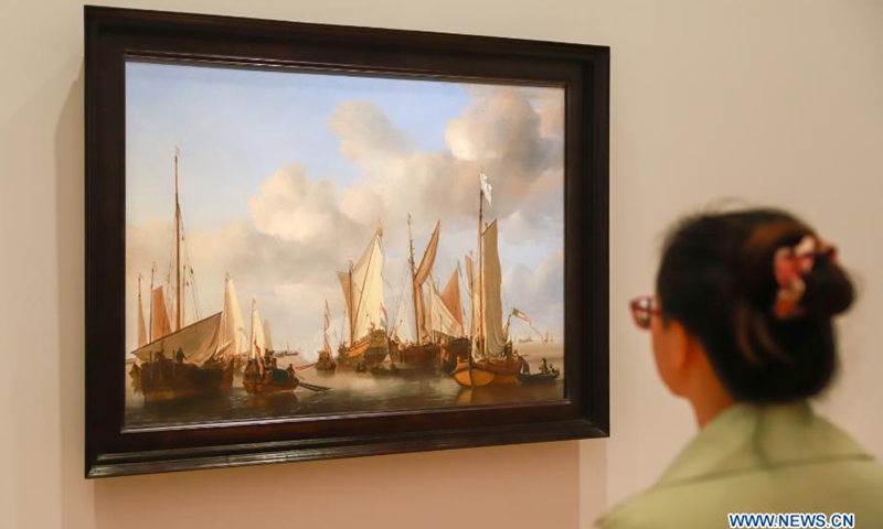 A visitor views a painting at the media preview of an exhibition in Canberra, Australia, on March 3, 2021. An exhibition with 61 paintings from the National Gallery London spanning nearly 500 years will start on Friday. It brought together works of 56 of European history's greatest artists including Botticelli, Titian, Velazquez, Rembrandt, Vermeer, Goya, Van Dyck, Canaletto, Turner, Renoir, Cezanne, Monet and Gauguin, and will run until June 14.Photo:Xinhua