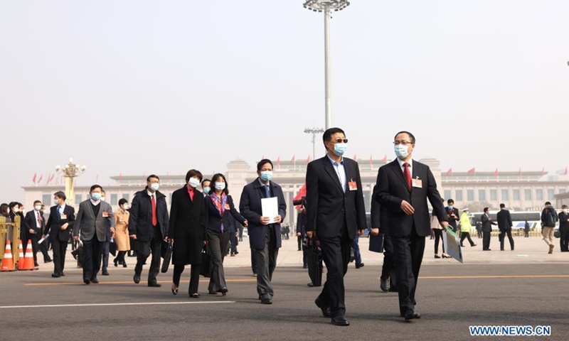 Members of the 13th National Committee of the Chinese People's Political Consultative Conference (CPPCC) walk towards the Great Hall of the People for the opening meeting of the fourth session of the 13th CPPCC National Committee in Beijing, capital of China, March 4, 2021. (Xinhua/Cao Can) 