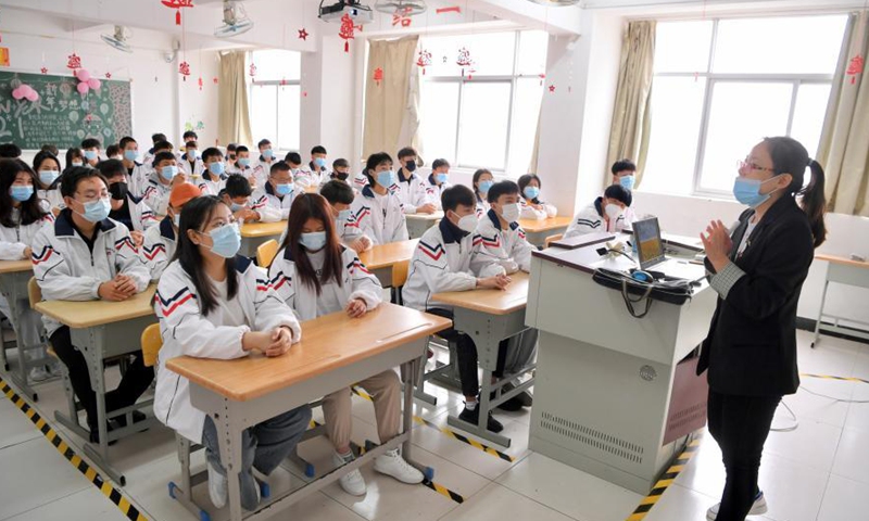 A teacher talks to students from northwest China's Ningxia Hui Autonomous Region at SCUD Senior Technical School in Fuzhou, southeast China's Fujian Province, March 4, 2021.. Photo:Xinhua