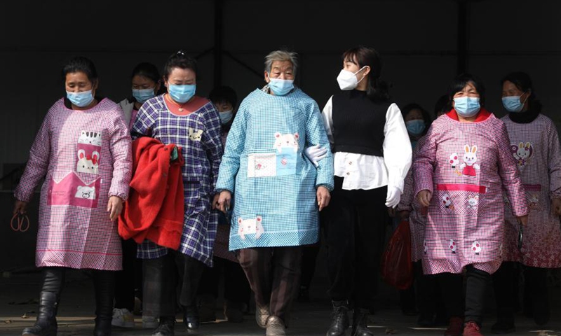 Yan Jiaxin (2nd R) and other female workers walk out of Yan's handicraft factory in Qiaotuo Village of Tai'an County, Anshan, northeast China's Liaoning Province, March 4, 2021. Yan Jiaxin is a household name in her hometown Qiaotuo Village, because the 21-year-old entrepreneur has been running a handicraft factory which employs local women and sells products to European markets.Photo:Xinhua