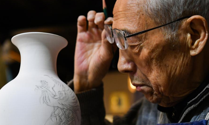 Ge Yuansheng shows a colored glaze handicraft in his workshop in Taiyuan, north China's Shanxi Province, Feb. 3, 2021. Photo:Xinhua