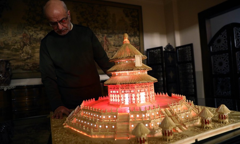 Ahmed Hassan shows the replica of Temple of Heaven made of matchsticks in Cairo, Egypt, on Feb. 26, 2021.(Photo: Xinhua)