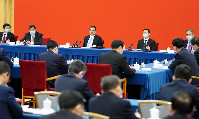 Chinese Premier Li Keqiang, also a member of the Standing Committee of the Political Bureau of the Communist Party of China Central Committee, visits national political advisors from the economic sector, and joins a group discussion with them at the fourth session of the 13th National Committee of the Chinese People's Political Consultative Conference (CPPCC) in Beijing, capital of China, March 6, 2021.(Photo: Xinhua)