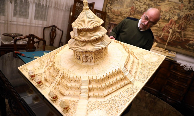 Ahmed Hassan shows the replica of Temple of Heaven made of matchsticks in Cairo, Egypt, on Feb. 26, 2021.(Photo: Xinhua)