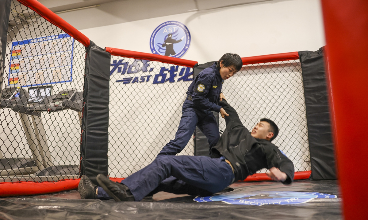 Liu Yao (left), a aviation security officer practices fighting skills with her colleague.