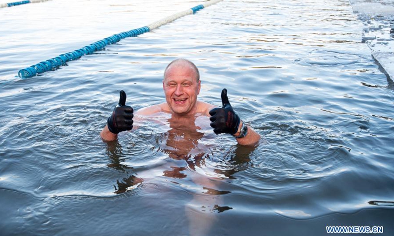 A swimmer gestures as he takes part in a winter swimming race on the Green Lake in Vilnius, Lithuania, on March 6, 2021. A 25-meter winter swimming race was held here on Saturday.Photo:Xinhua