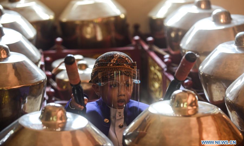 A beginner student plays music instruments during a Javanese puppetry class following health protocols amid the COVID-19 pandemic at Nirmala Sari hermitage in Cinere, Depok district, West Java, Indonesia, March 7, 2021.(Photo: Xinhua)