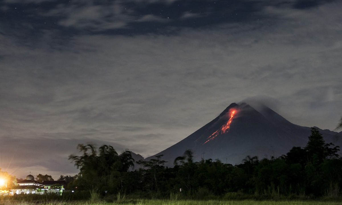 Photo taken on March 7, 2021 shows volcanic materials spewing from Mount Merapi as seen from Kaliurang, Yogyakarta, Indonesia. (Photo by Supriyanto/Xinhua)
