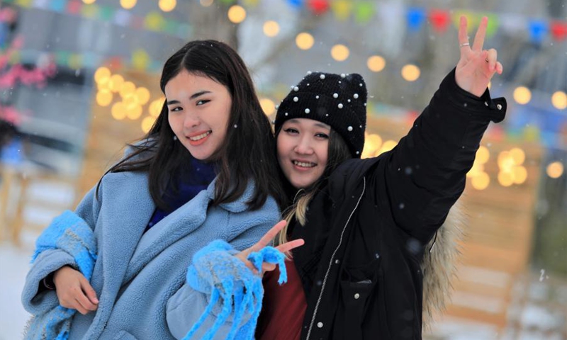 Two girls pose for photos at the Central Park in Nur-Sultan, Kazakhstan, March 7, 2021. People on Monday celebrated the International Women's Day with a variety of entertainments at the Central Park.Photo:Xinhua