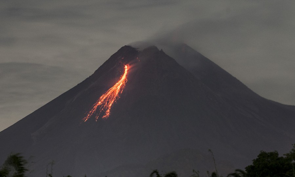 Photo taken on March 7, 2021 shows volcanic materials spewing from Mount Merapi as seen from Kaliurang, Yogyakarta, Indonesia. (Photo by Supriyanto/Xinhua)
