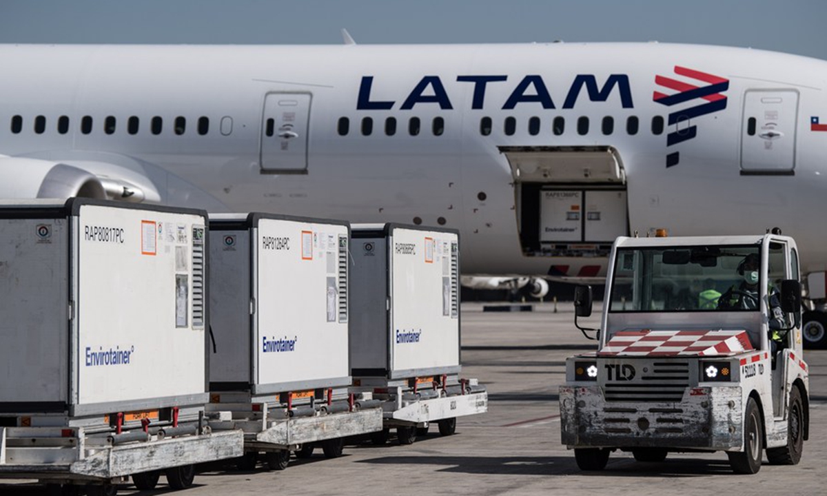 A worker drives a vehicle to carry containers loaded with vaccines developed by Chinese firm Sinovac Biotech at Santiago international airport in Santiago, Chile, Jan. 28, 2021. (Photo by Jorge Villegas/Xinhua)