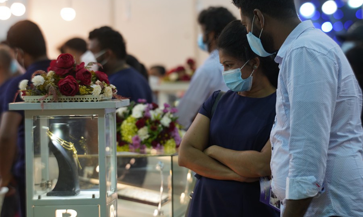 People wearing face masks talk during a wedding show in Colombo, Sri Lanka, on March 7, 2021. (Xinhua/Tang Lu)