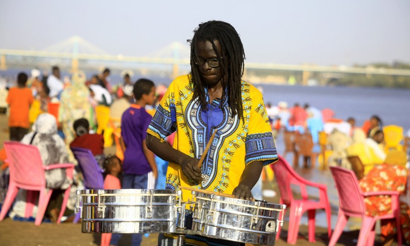 A man plays drums on the beach of the Blue Nile in Khartoum, Sudan, March 5, 2021.(Photo: Xinhua)