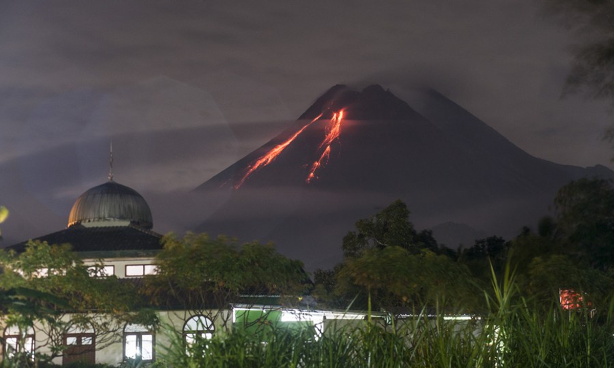 Photo taken on March 7, 2021 shows volcanic materials spewing from Mount Merapi as seen from Kaliurang, Yogyakarta, Indonesia. (Photo by Supriyanto/Xinhua)
