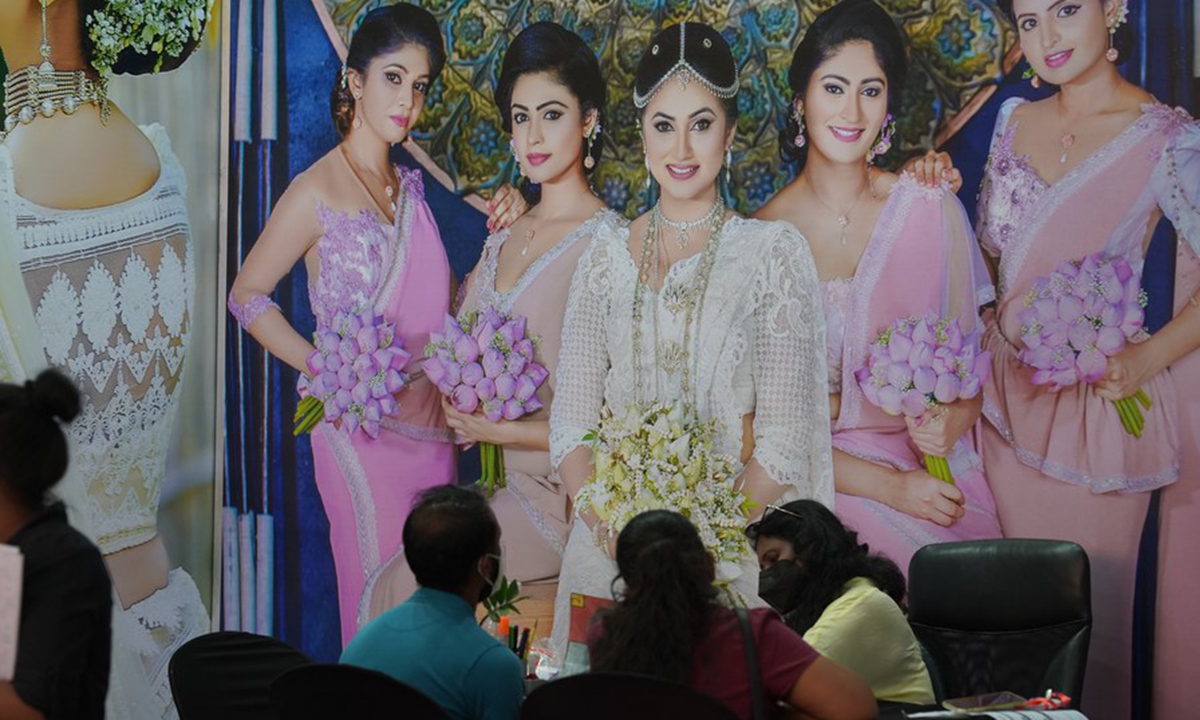 People wearing face masks talk during a wedding show in Colombo, Sri Lanka, on March 7, 2021. (Xinhua/Tang Lu)