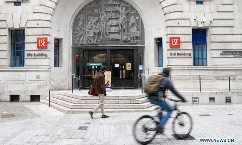 People are seen outside the Old Building of LSE (The London School of Economics and Political Science) in London, Britain, on March 8, 2021. Amid a mixed sense of nervousness and excitement, millions of children returned to schools across England on Monday under phase one of the British government's roadmap to recovery from the COVID-19 pandemic.(Photo: Xinhua)