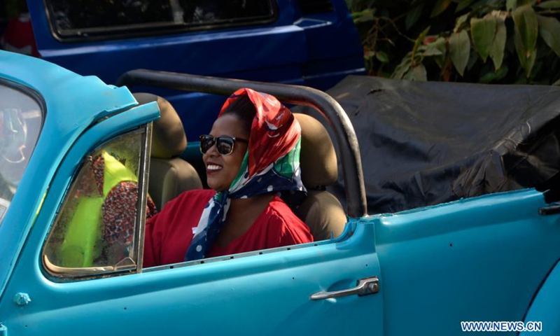 A woman sits in an automobile on display at a show in Kampala, Uganda, March 8, 2021. A show featuring over 40 vintage and classic automobiles was held in Kampala.Photo:Xinhua
