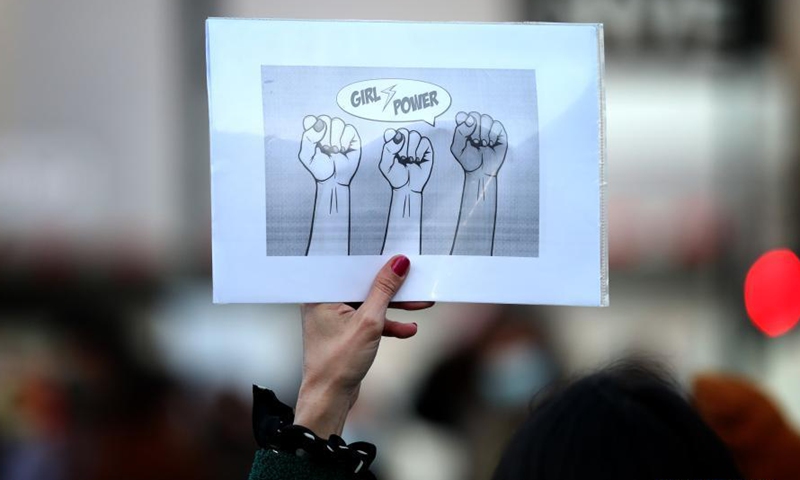A woman holding a signal takes part in a rally to mark the International Women's Day in downtown Lisbon, Portugal, on March 8, 2021.Photo:Xinhua