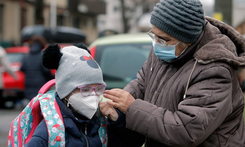 A child arrives at a school during the COVID-19 pandemic in Bucharest, Romania, Feb. 8, 2021.(Photo: Xinhua)