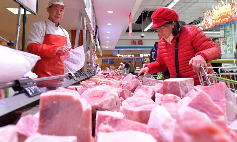 A woman buys pork at a supermarket in Nanchang, east China's Jiangxi Province, Dec. 22, 2019.(Photo: Xinhua)